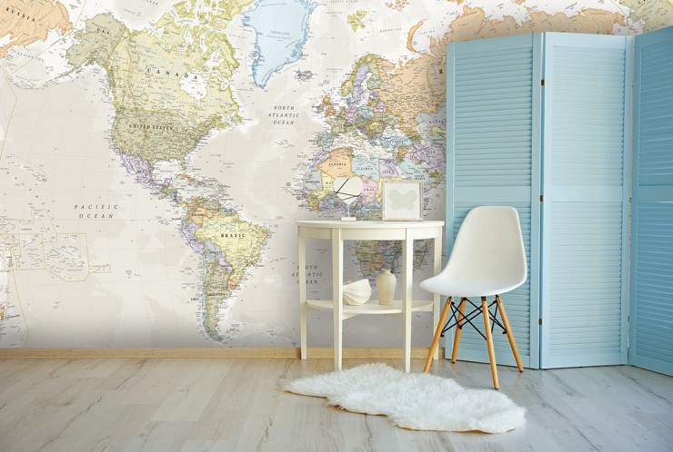 pastel toned world map wall mural in room with chair and fluffy white rug