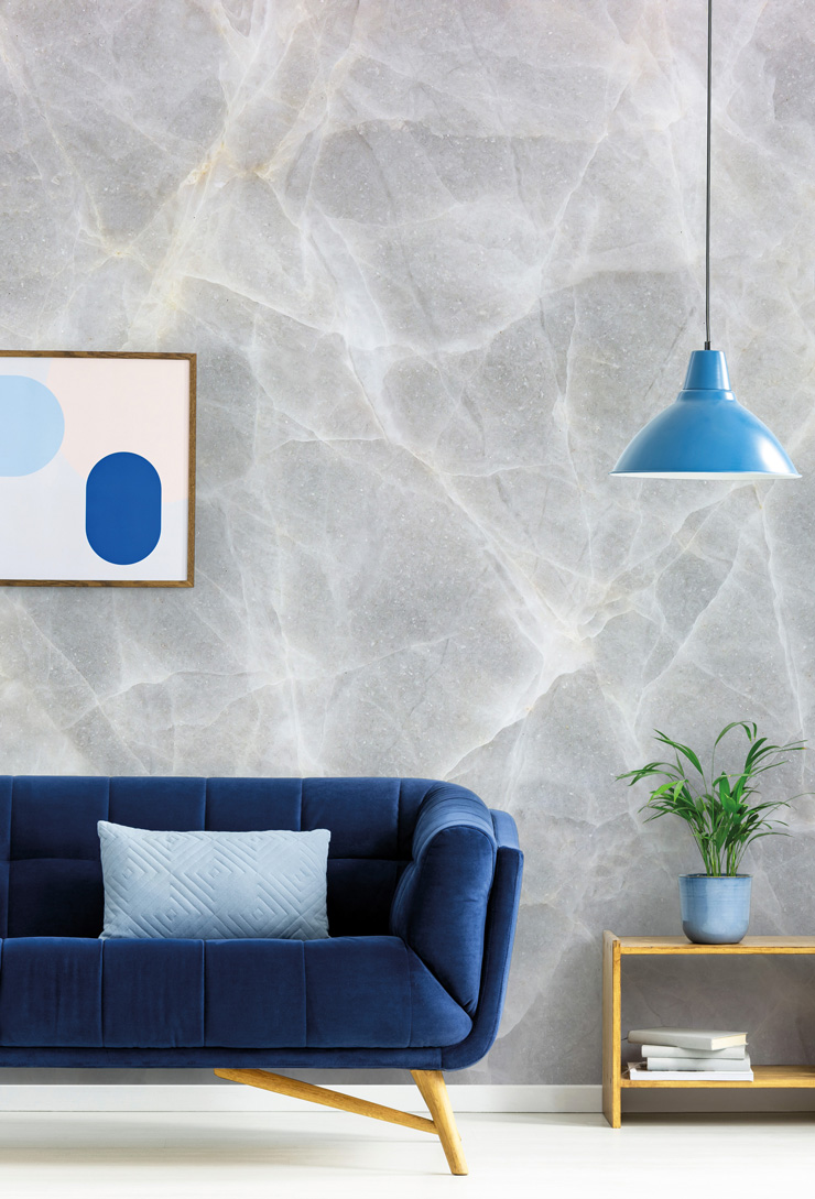 very pale grey marble wall mural in navy lounge