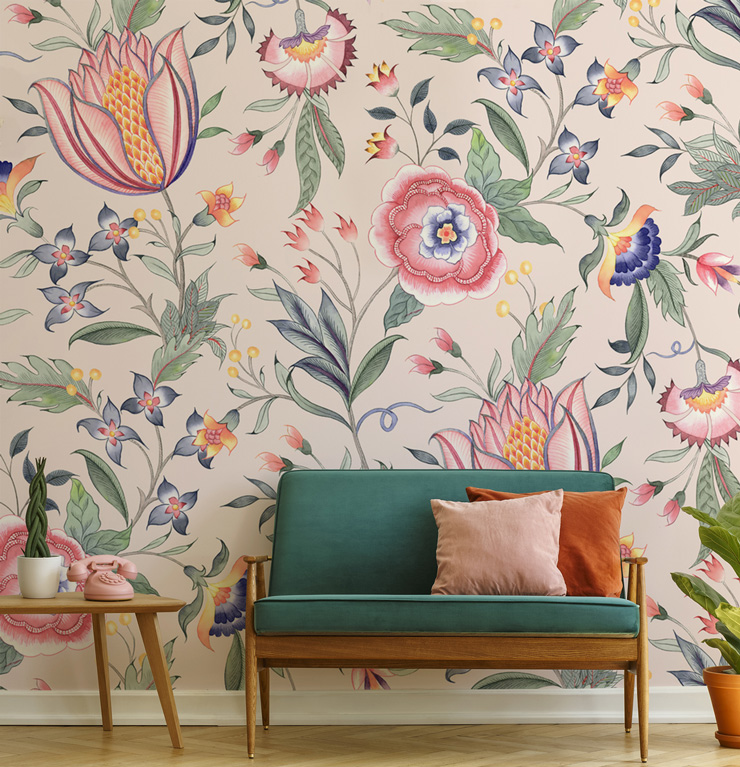 pale pink floral wallpaper with touches of blue and orange in trendy living room