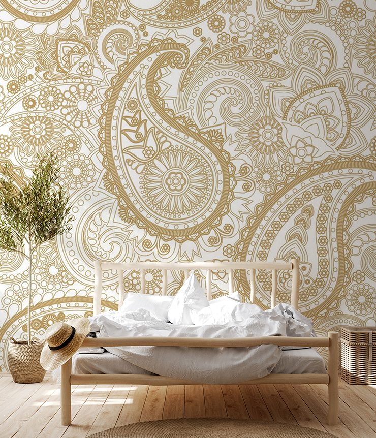 gold colour and cream paisley wallpaper in boho wood and rattan bedroom