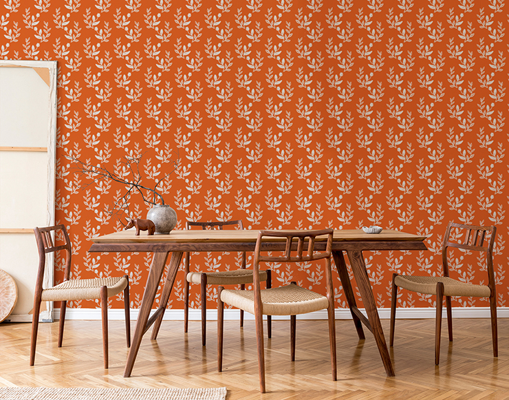 leaf pattern over orange wallpaper in wooden, minimalist dining area