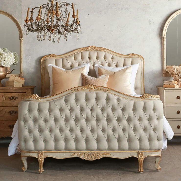 large chesterfield upholstered bed with buttons in gold tones