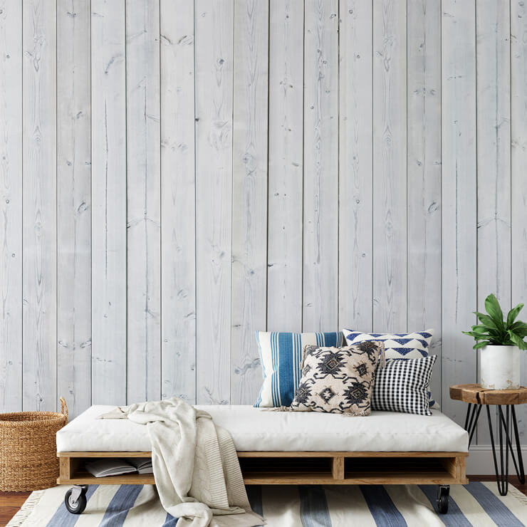 white panel wall mural in summer house with pallet chair
