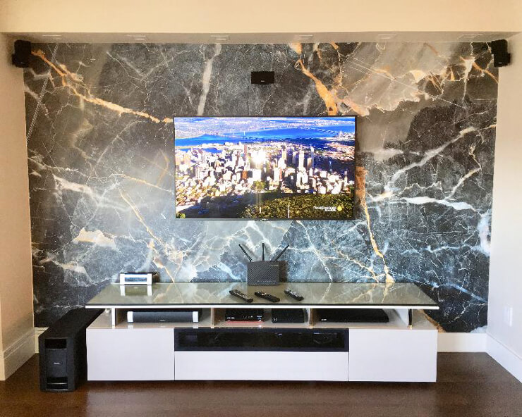 grey and gold colored marble wallpaper on wall with tv and console