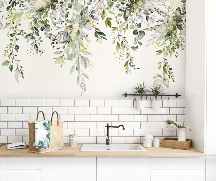 White kitchen cabinets with wooden worktops with a hanging botanical wall mural
