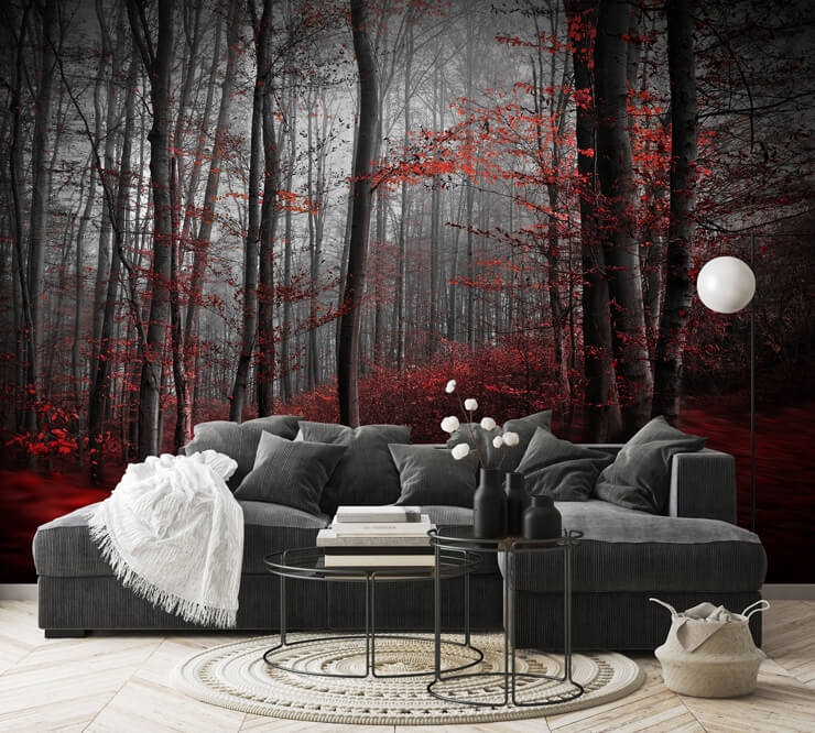 Dark red forest wallpaper in a living room with a dark grey and black sofa