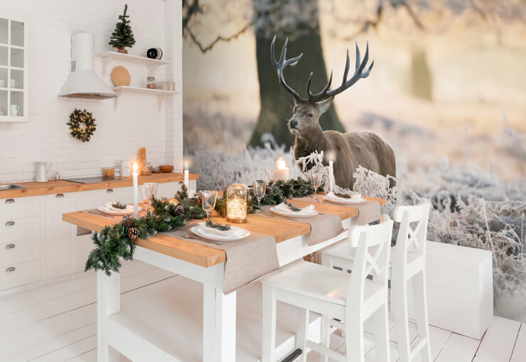 White kitchen with pine worktops and a pine dining table with a realistic stag wallpaper