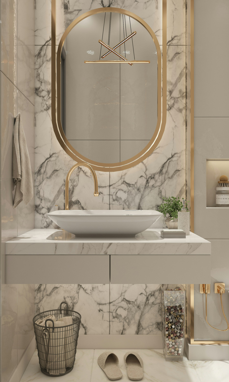 gold mirror and marble tiles in small bathroom