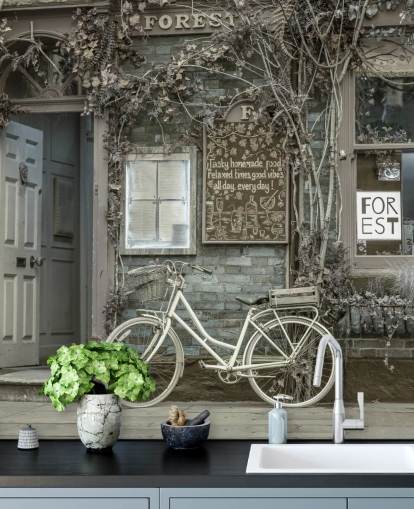 gray shop facade mural called Bicycle Outside a Cafe, York by Assaf Frank