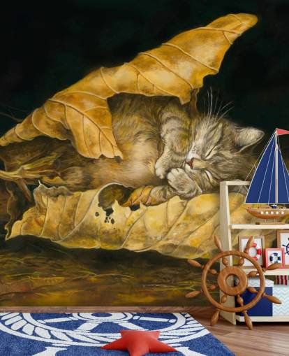 kitten asleep in autumn leaves