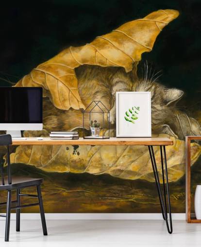 kitten asleep in autumn leaves