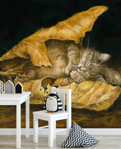 kitten asleep in autumn leaves