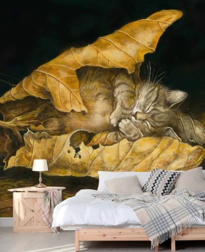 kitten asleep in autumn leaves