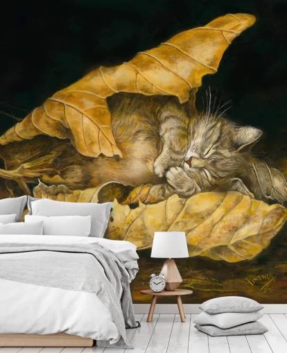 kitten asleep in autumn leaves