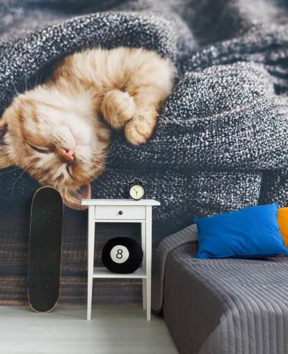 ginger kitten asleep on grey blanket