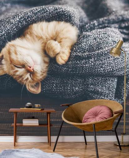 ginger kitten asleep on grey blanket