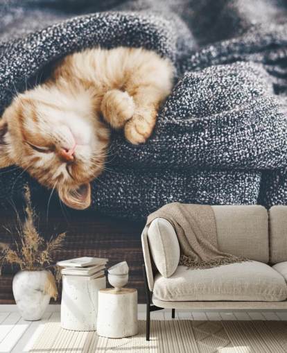ginger kitten asleep on grey blanket