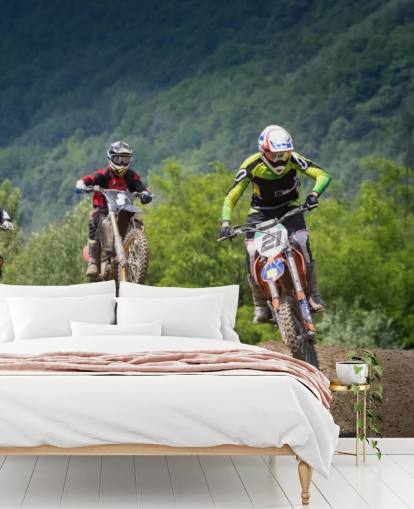 Motocross Racers Going Over a Hill Wallpaper