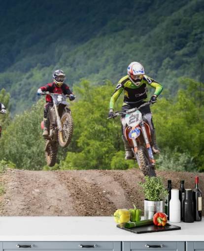 Motocross Racers Going Over a Hill Wallpaper