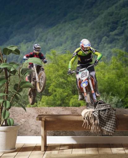 Fondo de pantalla de corredores de motocross que van sobre una colina