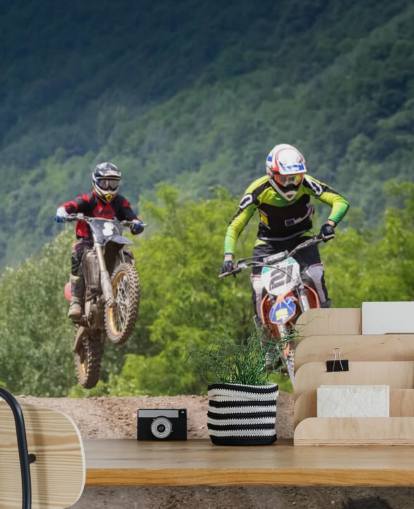 Motocross Racers Going Over a Hill Wallpaper