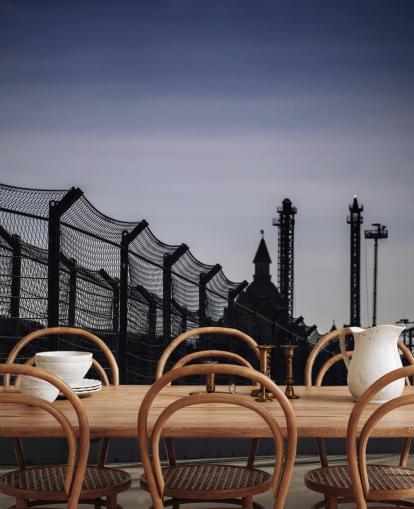 Lewis Hamilton Racing in Distance on Track Wallpaper