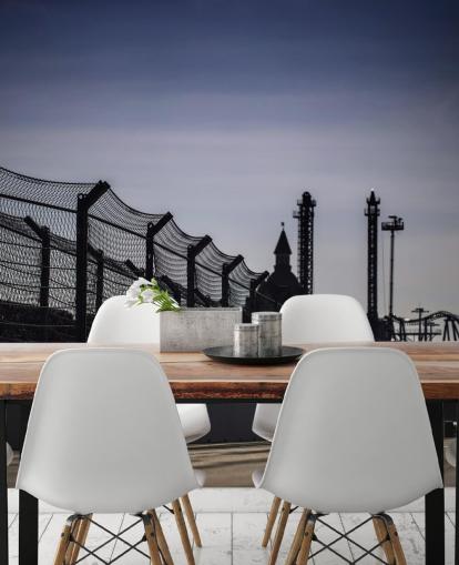 Lewis Hamilton Racing in Distance on Track Wallpaper