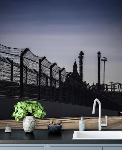 Lewis Hamilton Racing in Distance on Track Wallpaper