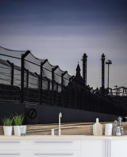 Lewis Hamilton Racing in Distance on Track Wallpaper