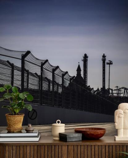 Lewis Hamilton Racing in Distance on Track Wallpaper