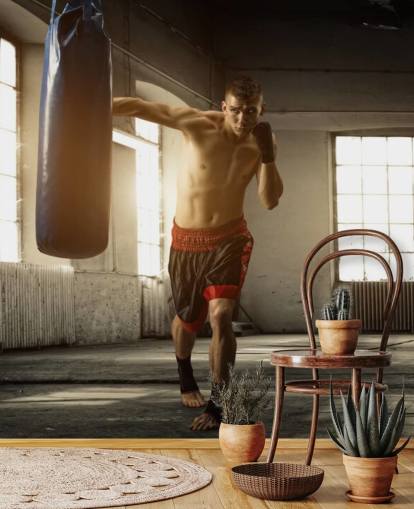 Young Man Boxing in Warehouse Wallpaper