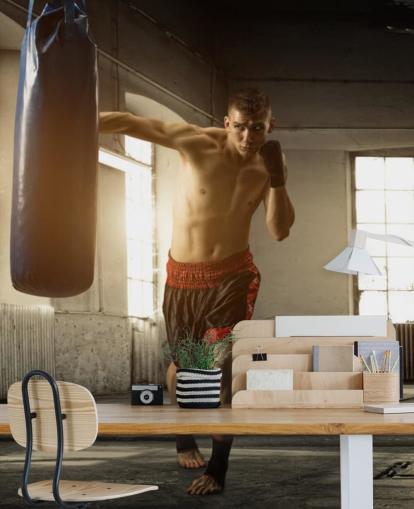 Young Man Boxing in Warehouse Wallpaper