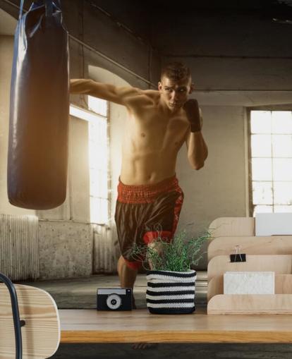 Young Man Boxing in Warehouse Wallpaper