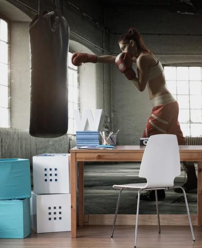 Young woman boxing workout in an old building wall mural