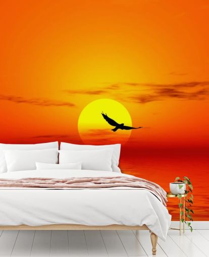 Vogel fliegt bei Sonnenuntergang über den Ozean Fototapete Vogel fliegt bei Sonnenuntergang über den Ozean Fototapete