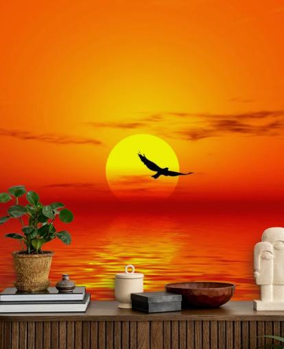 Vogel fliegt bei Sonnenuntergang über den Ozean Fototapete