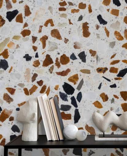 Terrazzo med brunt och svart flis på vit bakgrund Bakgrund