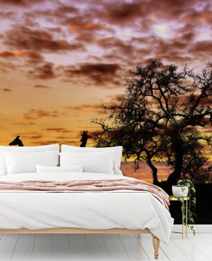 silhuetas de girafas e elefantes contra o papel de parede do céu ao pôr do sol