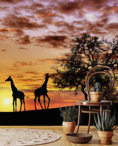 sagome di giraffe ed elefanti sullo sfondo del cielo al tramonto