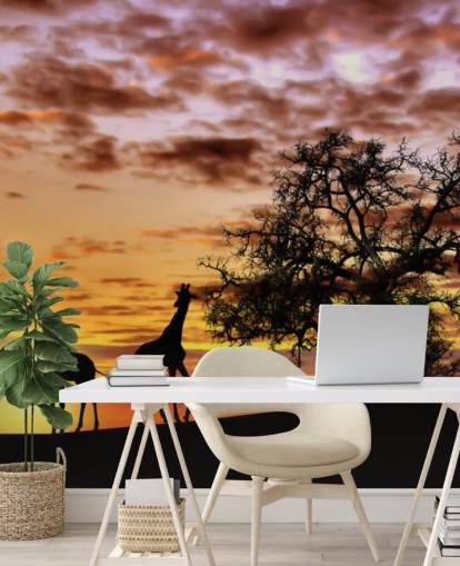 behang giraffen en olifanten silhouetten tegen zonsonderganghemel