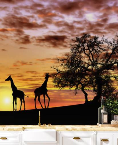 sagome di giraffe ed elefanti sullo sfondo del cielo al tramonto