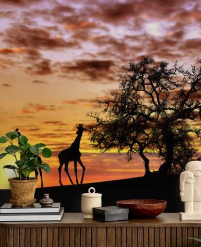 sagome di giraffe ed elefanti sullo sfondo del cielo al tramonto