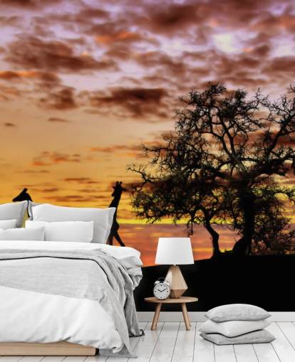 silhuetas de girafas e elefantes contra o papel de parede do céu ao pôr do sol