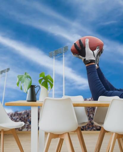 NFL-pelaajan kiinnipallo väkijoukon taustakuvalla