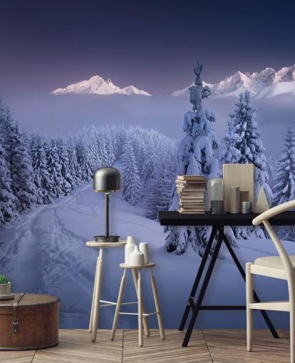 snowy forest and piste with mountains in the distance wallpaper