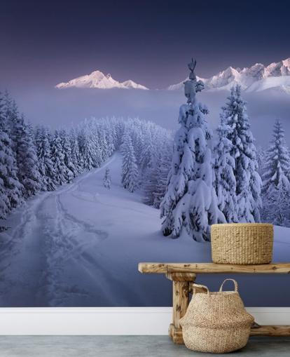 snowy forest and piste with mountains in the distance wallpaper