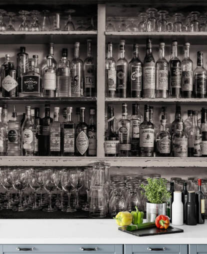 black and white bottles on shelf behind a bar wallpaper