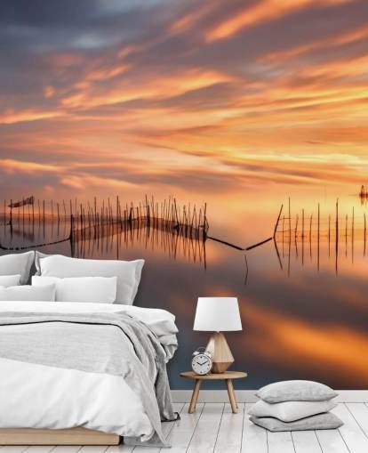 fishnet silhouettes in ocean against sunset sky wallpaper