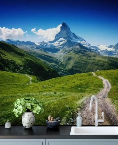 snowy peak of mountain above lush green field wallpaper