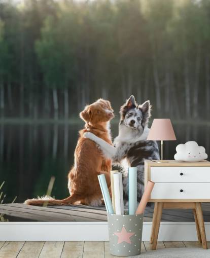 two dogs sat by a lake with arms around each other wall mural